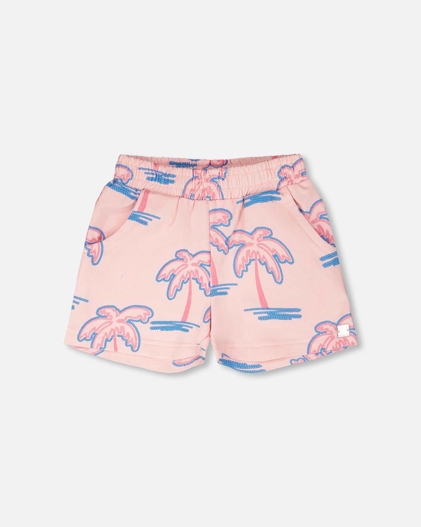 Pink shorts with palm tree pattern on a light gray background