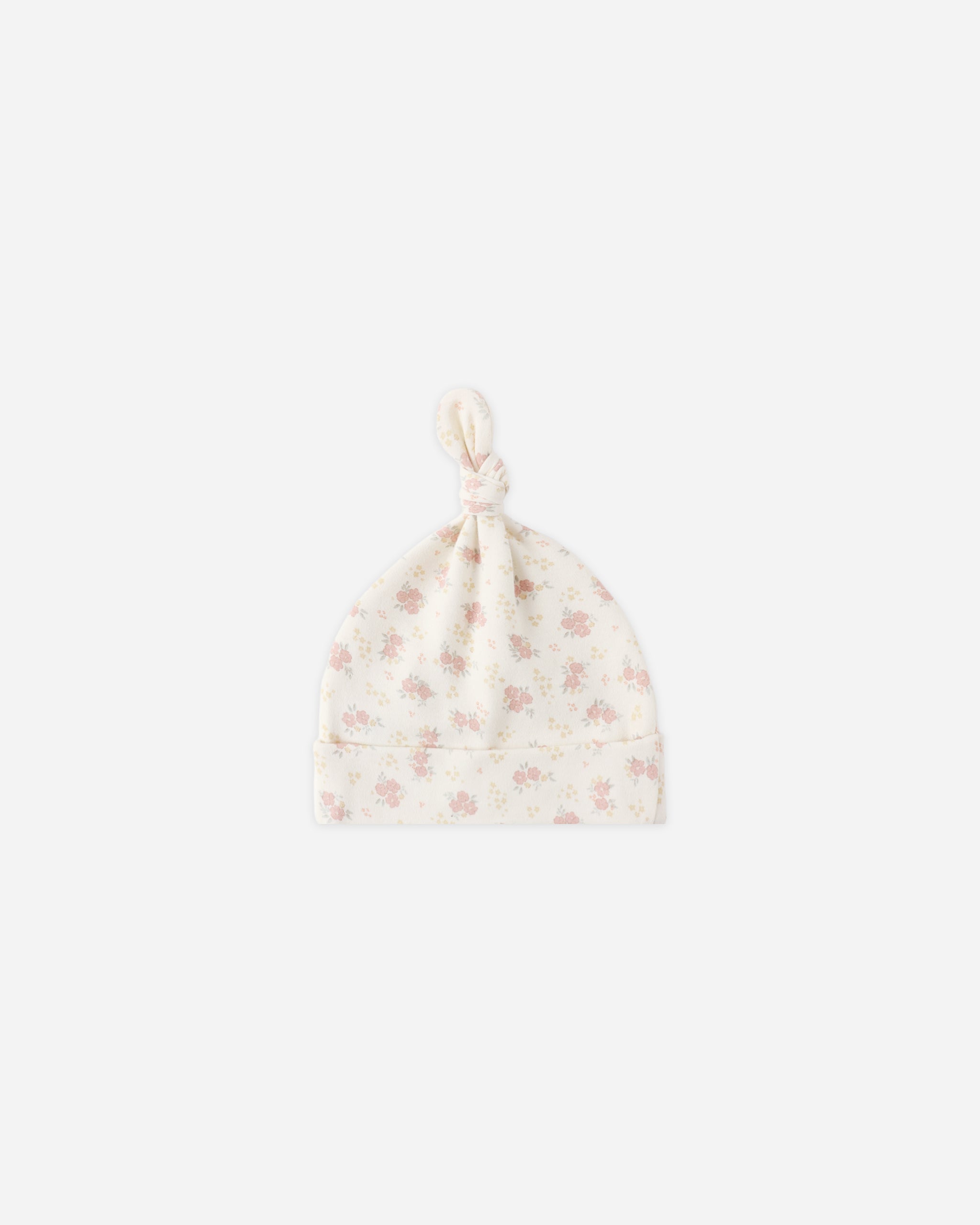 Floral patterned baby hat on a white background