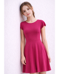 Woman wearing a pink dress against a white background